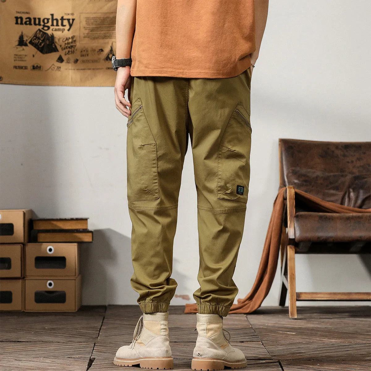 Men's khaki harem pants with tapered legs and ankle bands, made from non-iron cotton fabric.