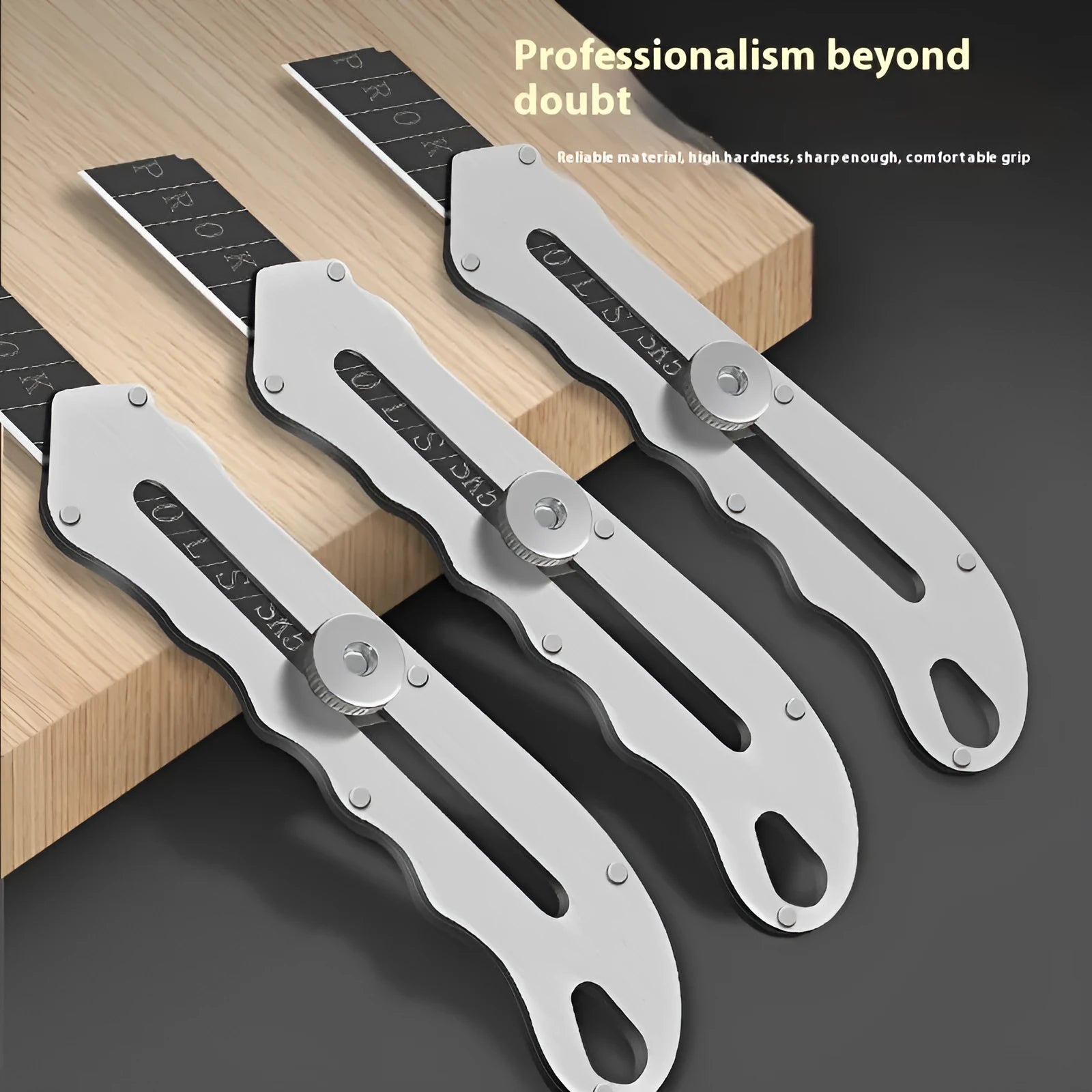Stainless steel folding art knife with a black blade, shown with long and trapezoidal replacement blades.