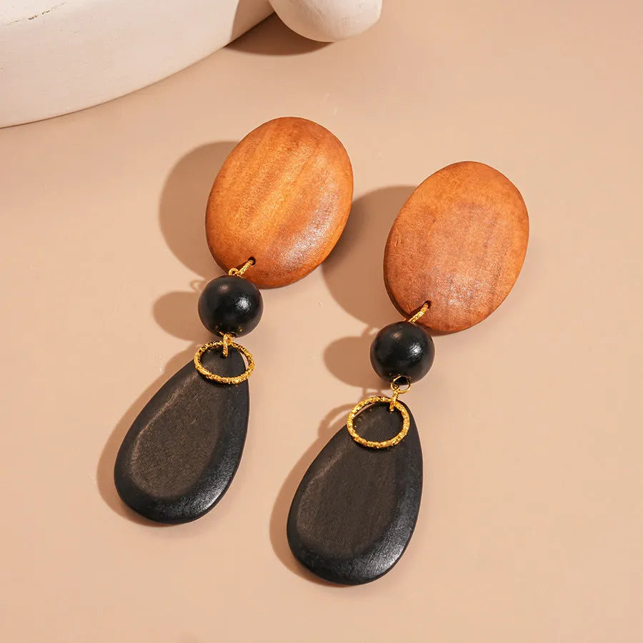 Handcrafted wooden earrings with elliptical design in silver brown black colours