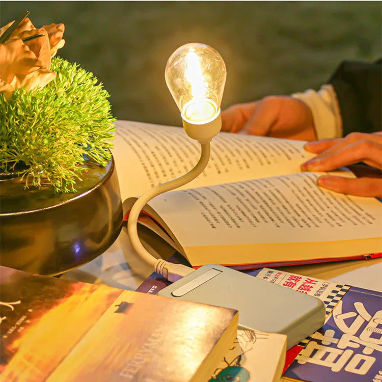 USB rechargeable folding tungsten night light with glowing S14 bulb on a table.