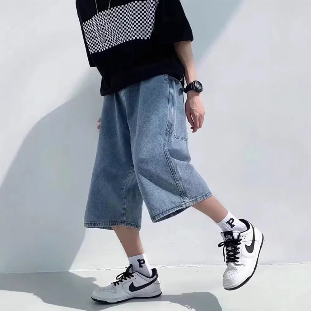 Men's blue washed denim shorts with high waist, cropped length, and straight-leg design on a model