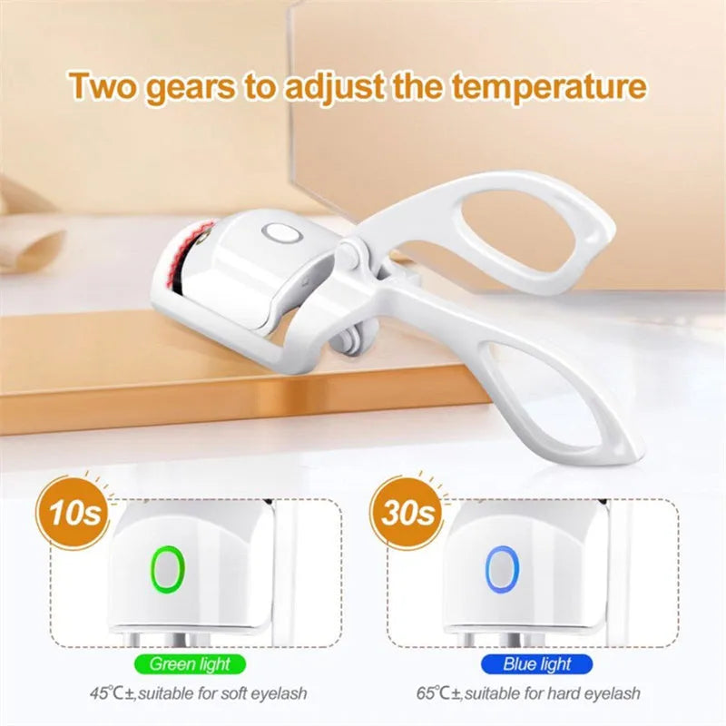 Pink and white USB rechargeable heated eyelash curler with temperature control buttons.