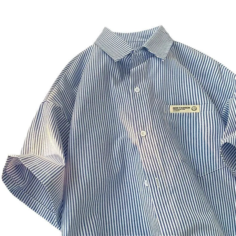 A blue and green striped, loose-fitting plus size shirt with half sleeves, shown in a cardigan style.