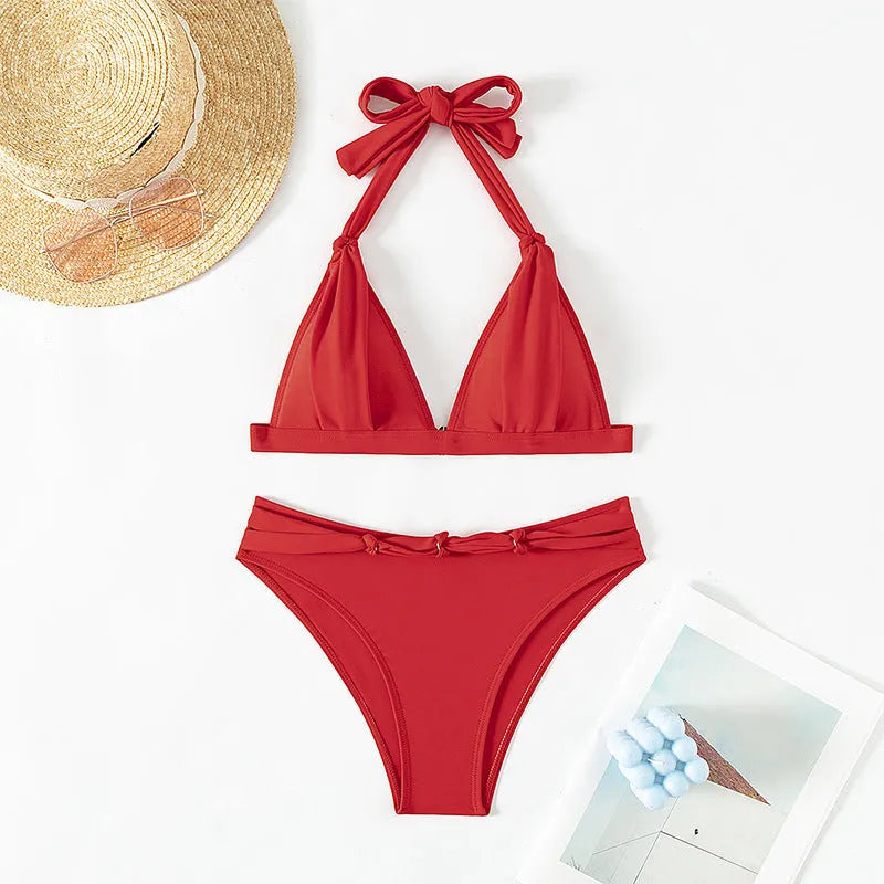 Red women's halterneck bikini with front lace-up detail and high-leg split shorts