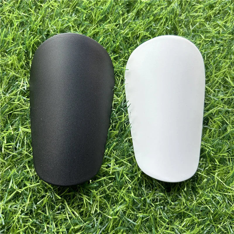 Extra small mini football shin guards in black and white measuring 8x5cm