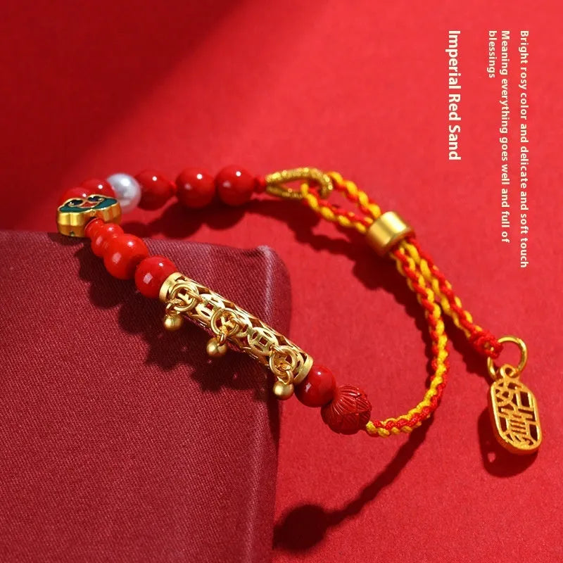 Red rope woven bracelet with round cinnabar charm and small bell for women