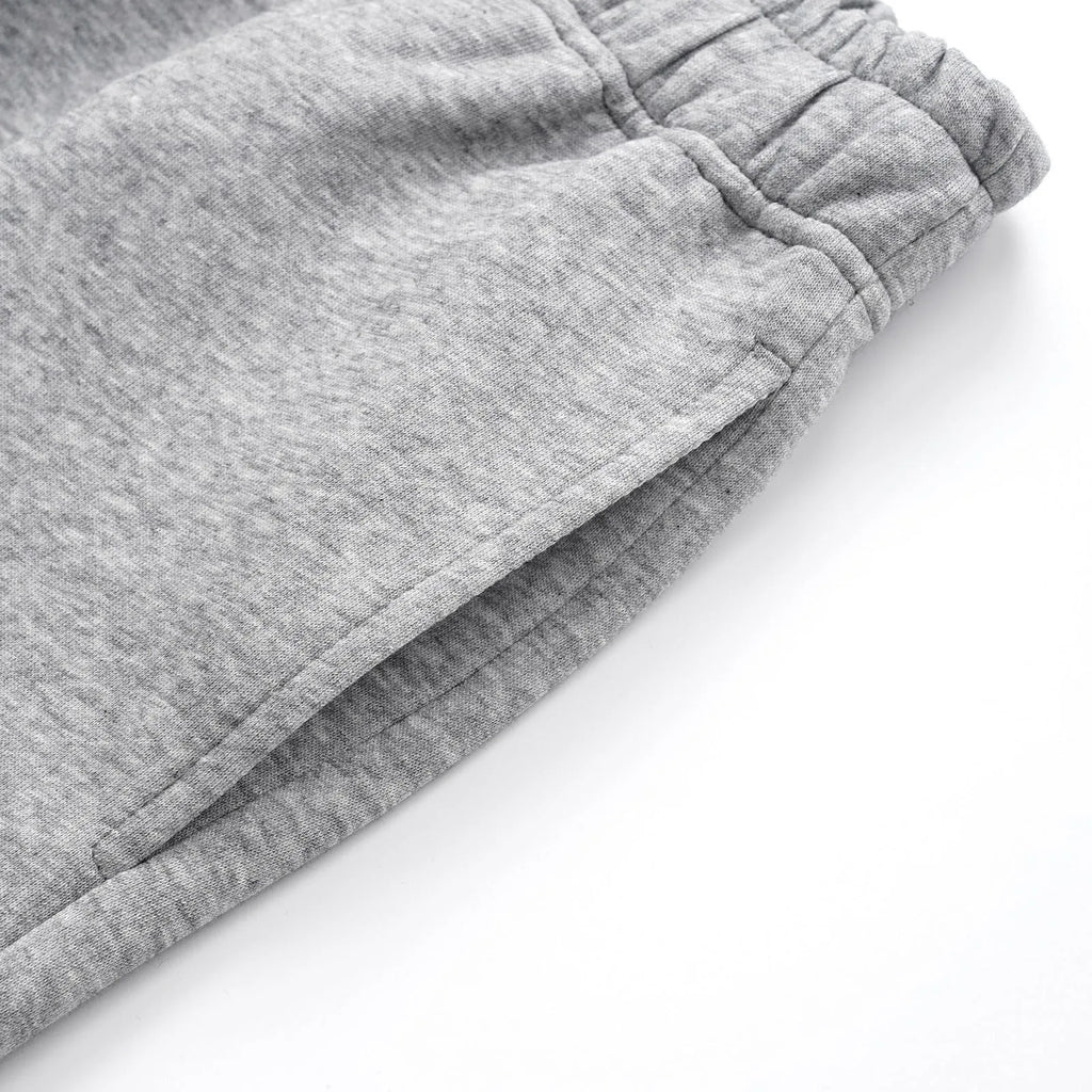Men's grey straight-leg cotton trousers with elasticated waistband and loose casual fit
