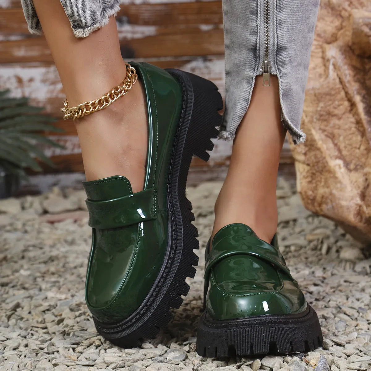 Plus size slip-on loafers with chunky heel in black, green, and wine red colours on a solid background