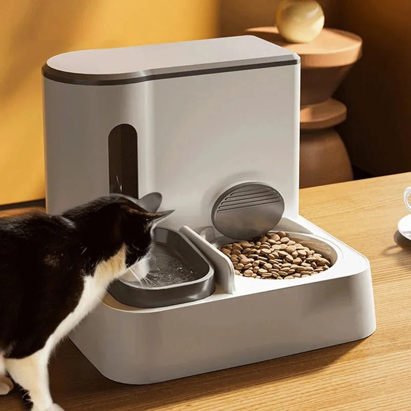 Gray automatic cat feeder with double bowl system showing food and water compartments