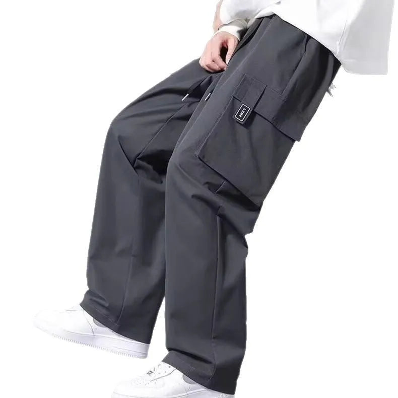 Boys' straight leg cargo trousers in army green with large cargo pockets and a drawstring waistband.