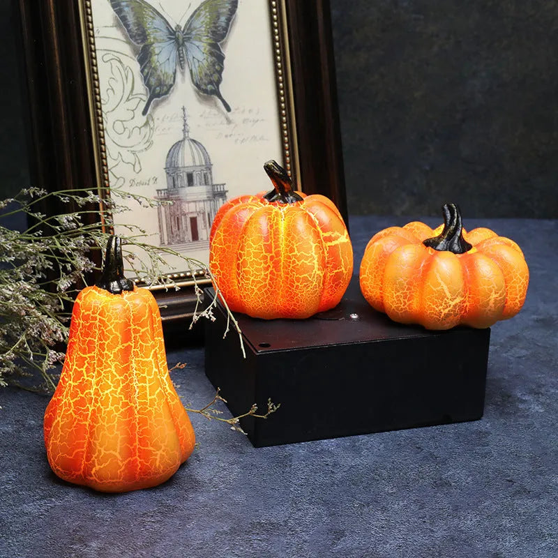 Set of three resin Halloween pumpkin lanterns with LED candle lights in short, medium, and long sizes.