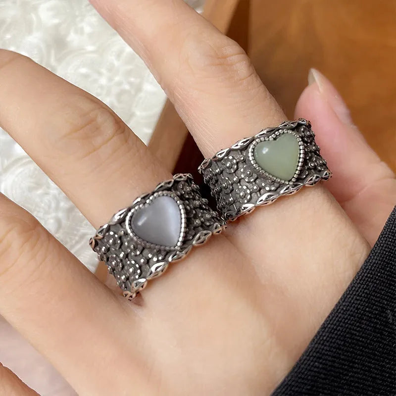 Retro wide-faced heart-shaped ring with adjustable opening in white copper plated silver, showing love-themed details