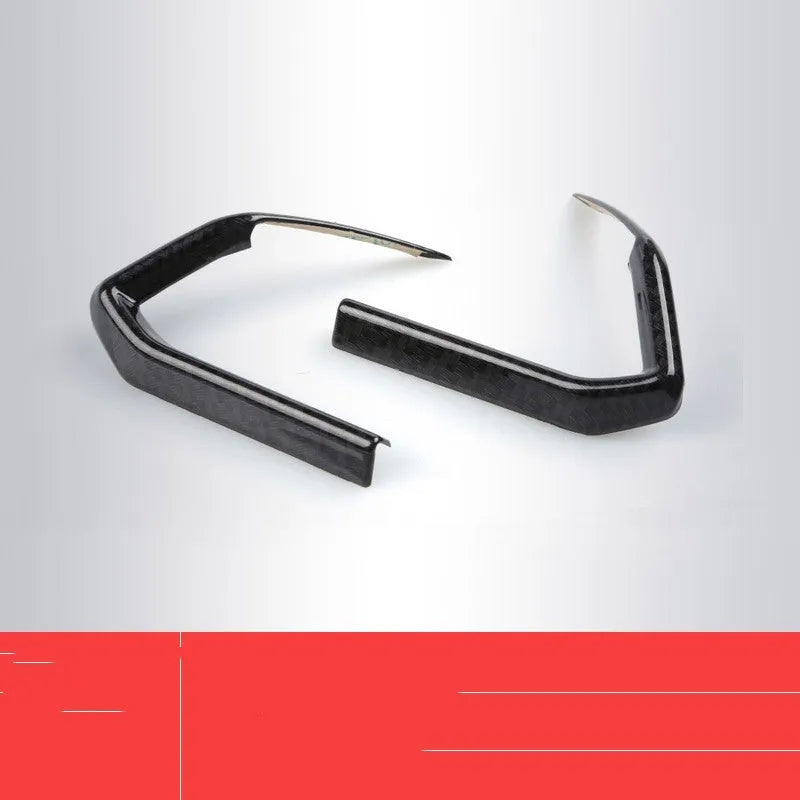 Pair of carbon fibre effect ABS plastic steering wheel frame covers for adhesive installation.