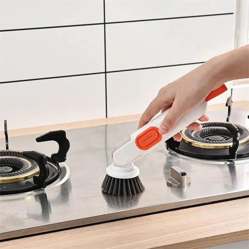 Long-handle kitchen cleaning brush with integrated soap dispenser and two removable brush heads, in white and red colour option.