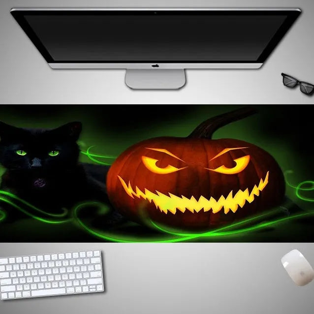 Oversized Halloween-themed mouse pad on desk with non-slip rubber cloth base and large surface area