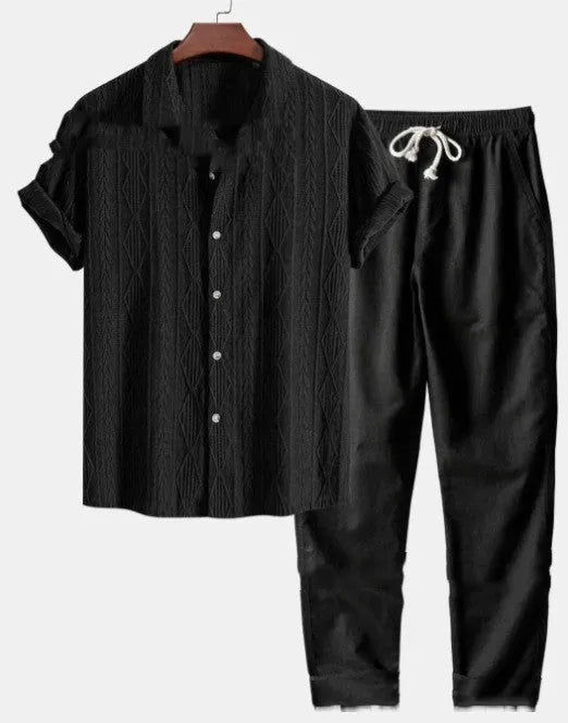 Man wearing a loose-fitting short sleeve shirt and trousers from a milk silk summer suit set.
