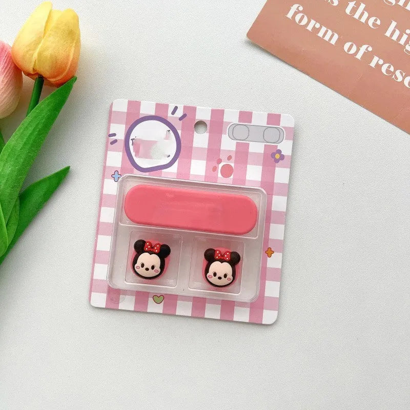 Cartoon-style magnetic plastic cable fixer clip in various colours on a metallic desk surface.