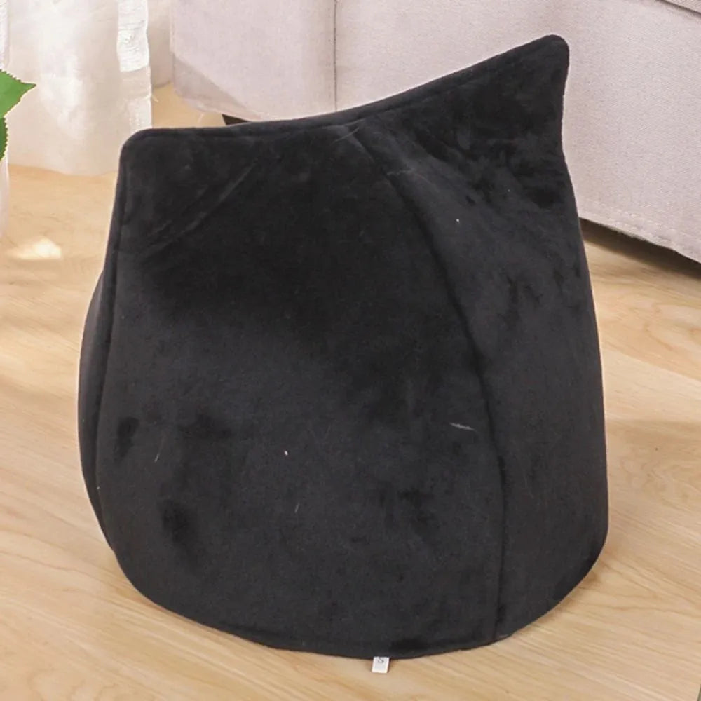 Grey covered cat cave pet bed with cat face design and anti-slip bottom.
