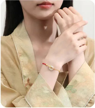 Gold electroplated 925 silver women's bracelet with koi and peace buckle design on adjustable red rope
