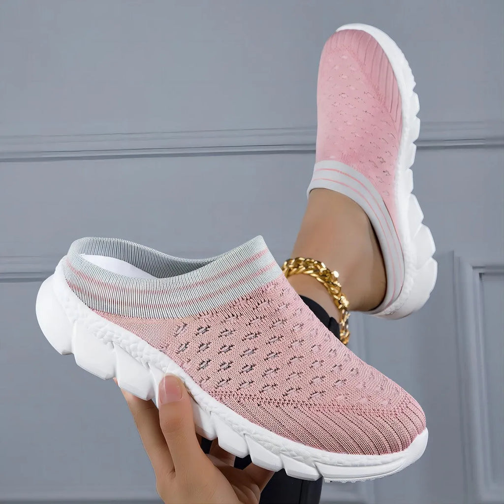 Women's black Flyknit slipper shoes with striped pattern and hollowed-out design on a white background.
