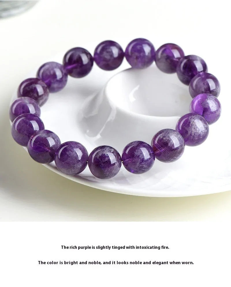 Natural feather amethyst crystal bracelet with scattered geometric beads showing purple crystal patterns and Ruyi elements
