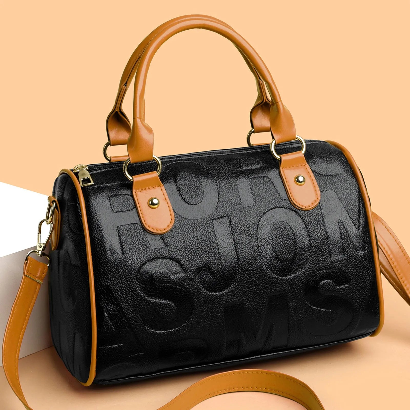 Brown cylindrical PU leather crossbody bag with three shoulder straps showing interior organisation
