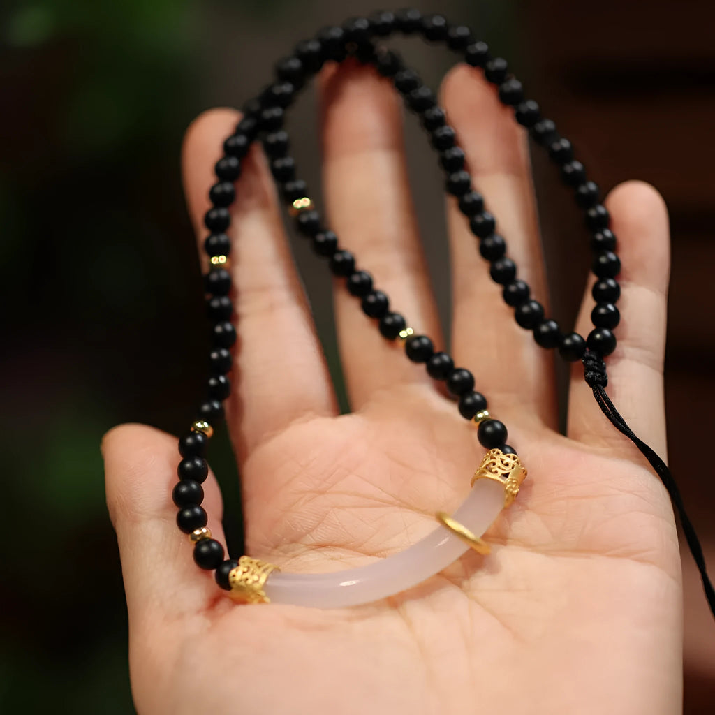 Chinese style U-shaped frosted black agate and white chalcedony necklace on beaded silver chain.