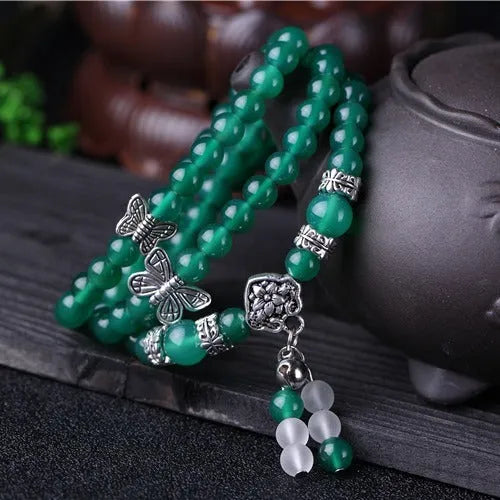 Close-up of a green agate multi-layer bracelet with three strands of 6mm round beads.