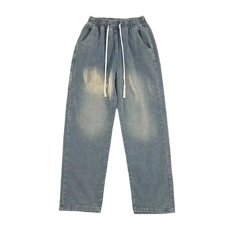 Men's straight-leg blue jeans with drawstring waist closure laid flat