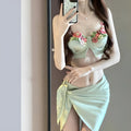 Green women's triangle bikini three-piece swimsuit set with matching skirt