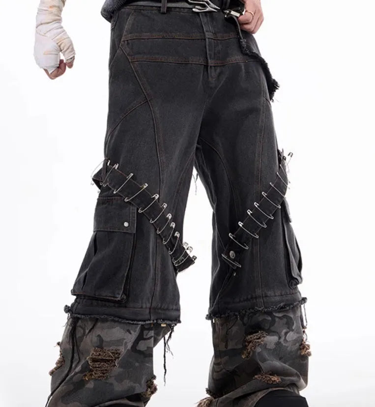 Men's grey jeans with camouflage pattern splicing and pin ribbon details on the legs.