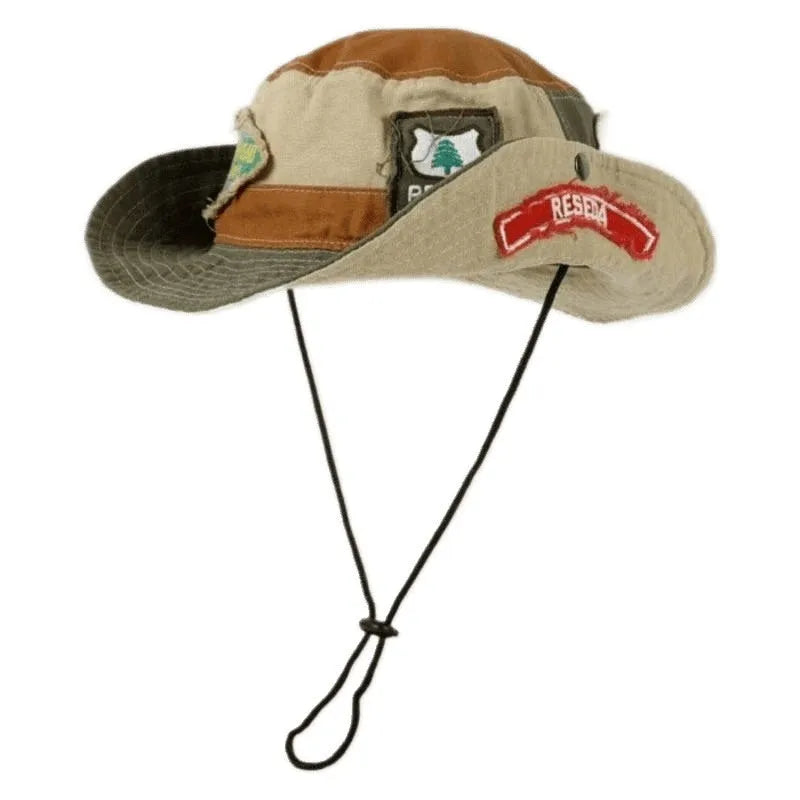 Army green cotton fisherman hat with hand-painted patchwork on flat top crown, folded for storage