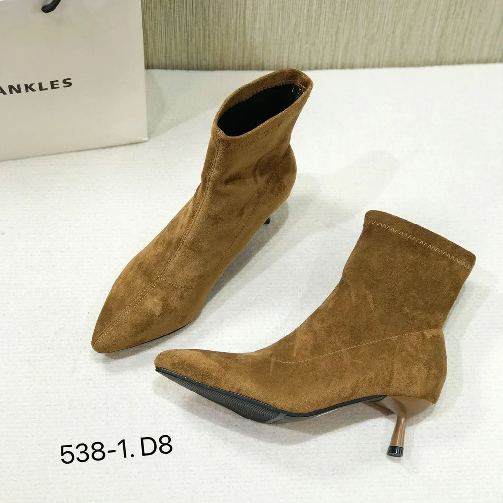 Women's black pointed toe ankle boots with a high stiletto heel on a microfiber upper.