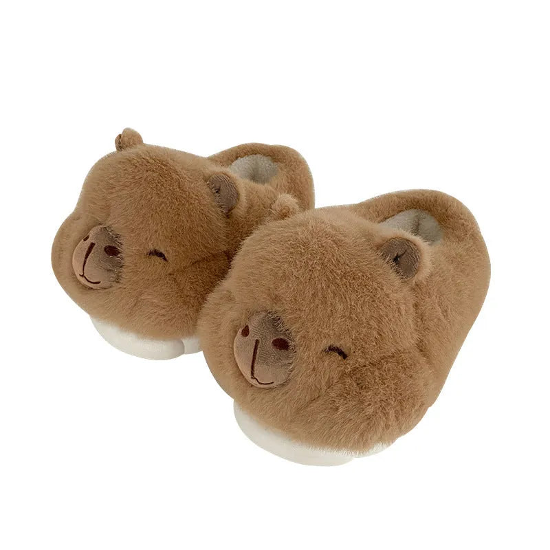 Light brown women's fleece slippers with a cartoon pattern, artificial wool lining, and a PVC sole.