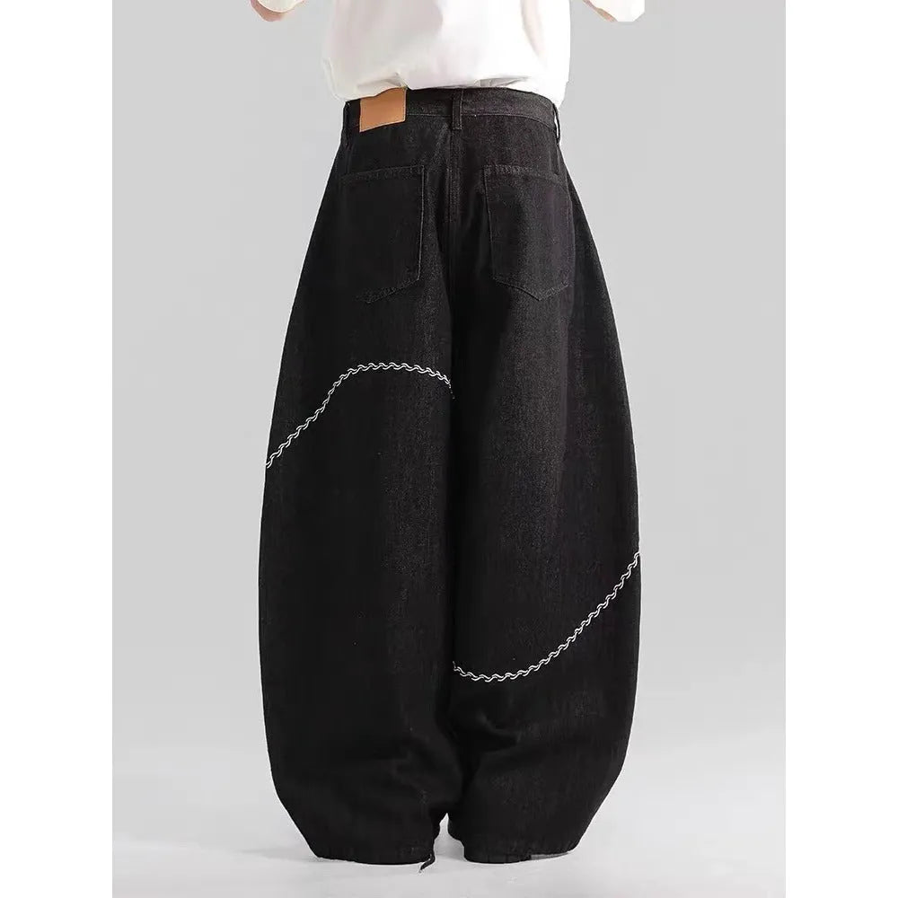 Black straight-leg denim trousers with mid-waist and zip placket on hanger showing micro-elastic polyester fabric