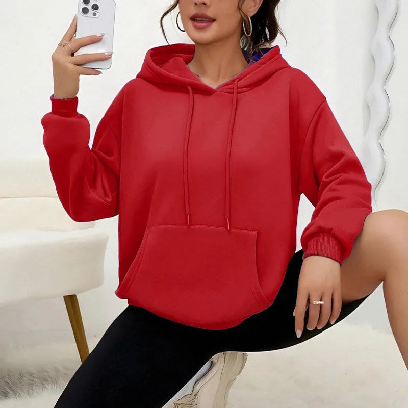 Women's loose grey sweatshirt with long sleeves and a front drawstring pocket, shown in a relaxed fit.