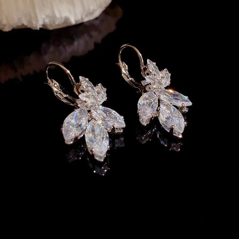 A pair of platinum-coloured alloy earrings in a leaf shape with an inlaid zircon shiny finish.