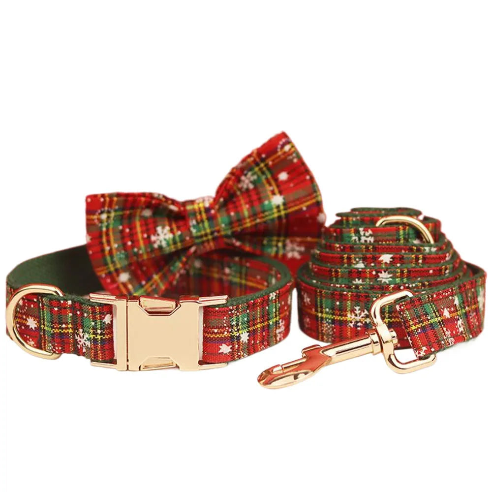 Green snowflake patterned cloth dog collar set with matching vest, leash, and bow for Christmas