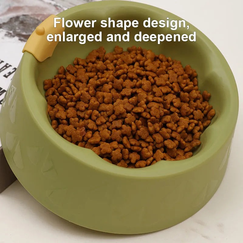 Flower-shaped green plastic double pet bowl for cat and dog food and water on a white surface.