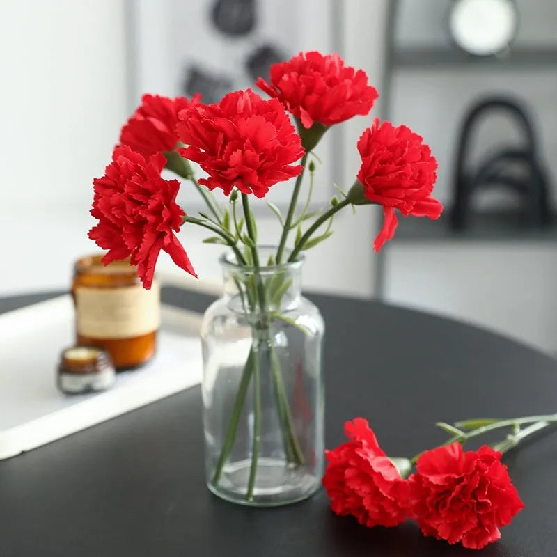 Artificial carnation flower with silk petals on soft rubber base in four colour options