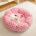 Pink dot pattern fabric cat bed shown in two circular sizes, 45cm and 65cm diameter.