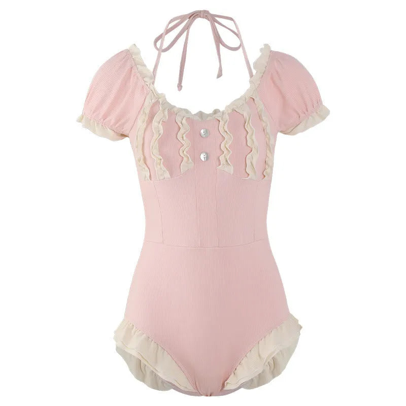 A pink women's conservative one-piece swimsuit on a white background.