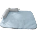 Blue pet bed cushion with big-eyed monster design on a wooden floor.