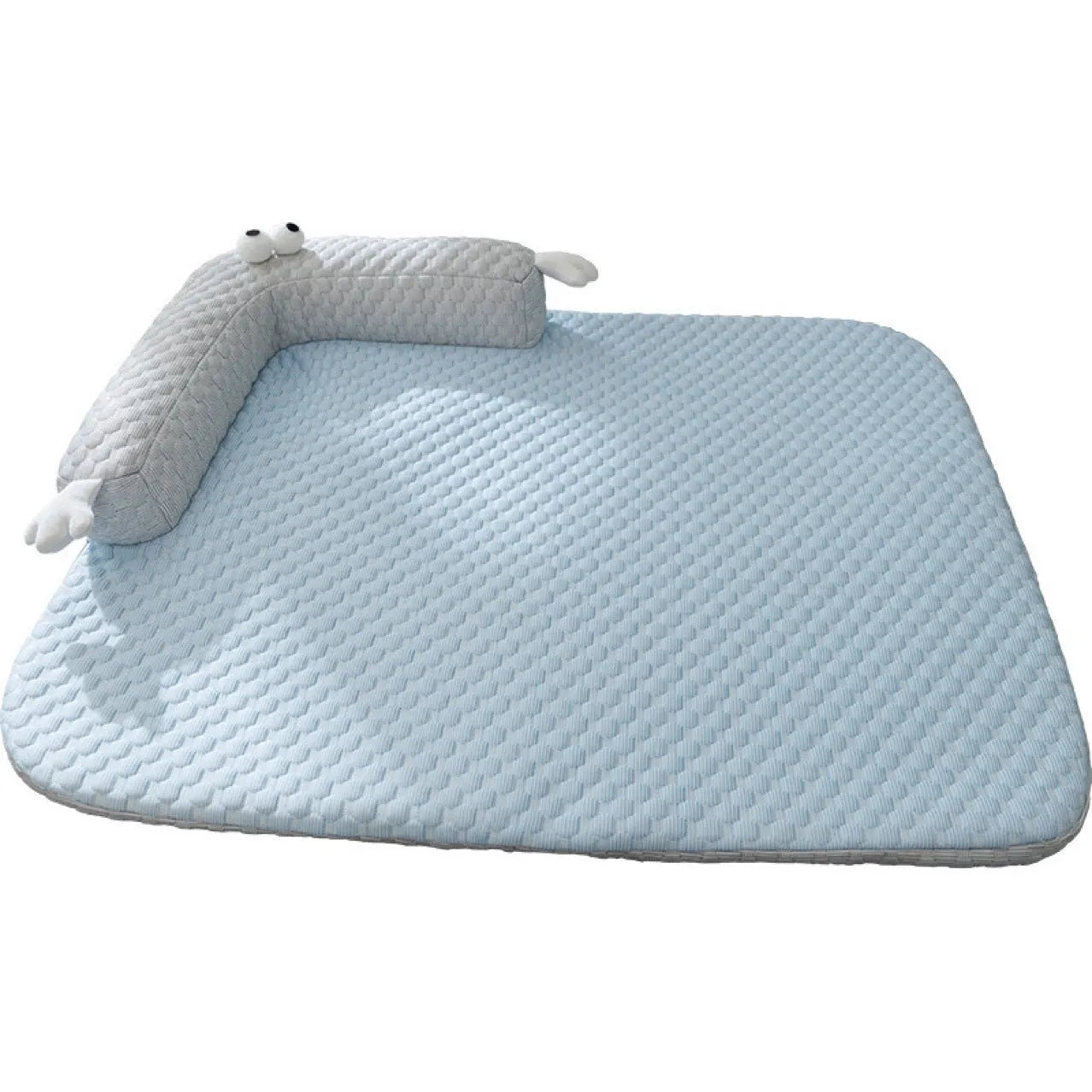 Blue pet bed cushion with big-eyed monster design on a wooden floor.