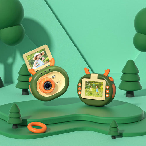 Purple and dark green children's digital camera with flip screen, silicone case lanyard, measuring 9.8cm by 7.9cm by 3.8cm