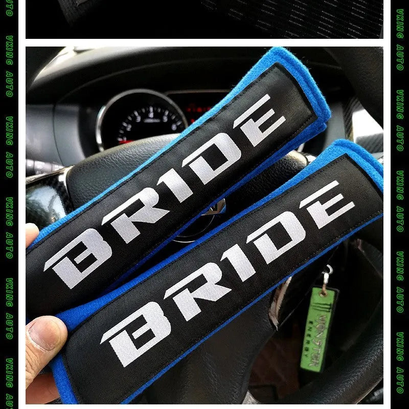 Pair of black sponge cloth car seat belt shoulder protector covers on a car seat.