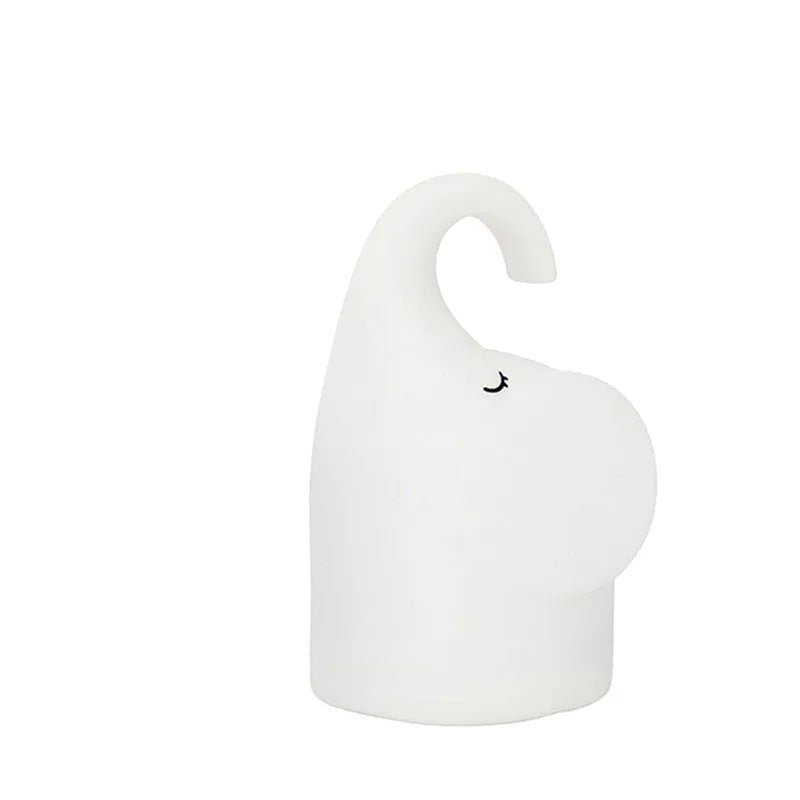 Elephant-shaped silicone night light with warm white LED glow, measuring 96mm wide by 151mm high