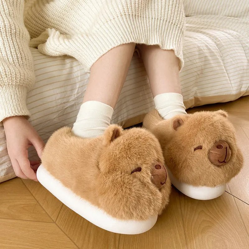 Light brown women's fleece slippers with a cartoon pattern, artificial wool lining, and a PVC sole.