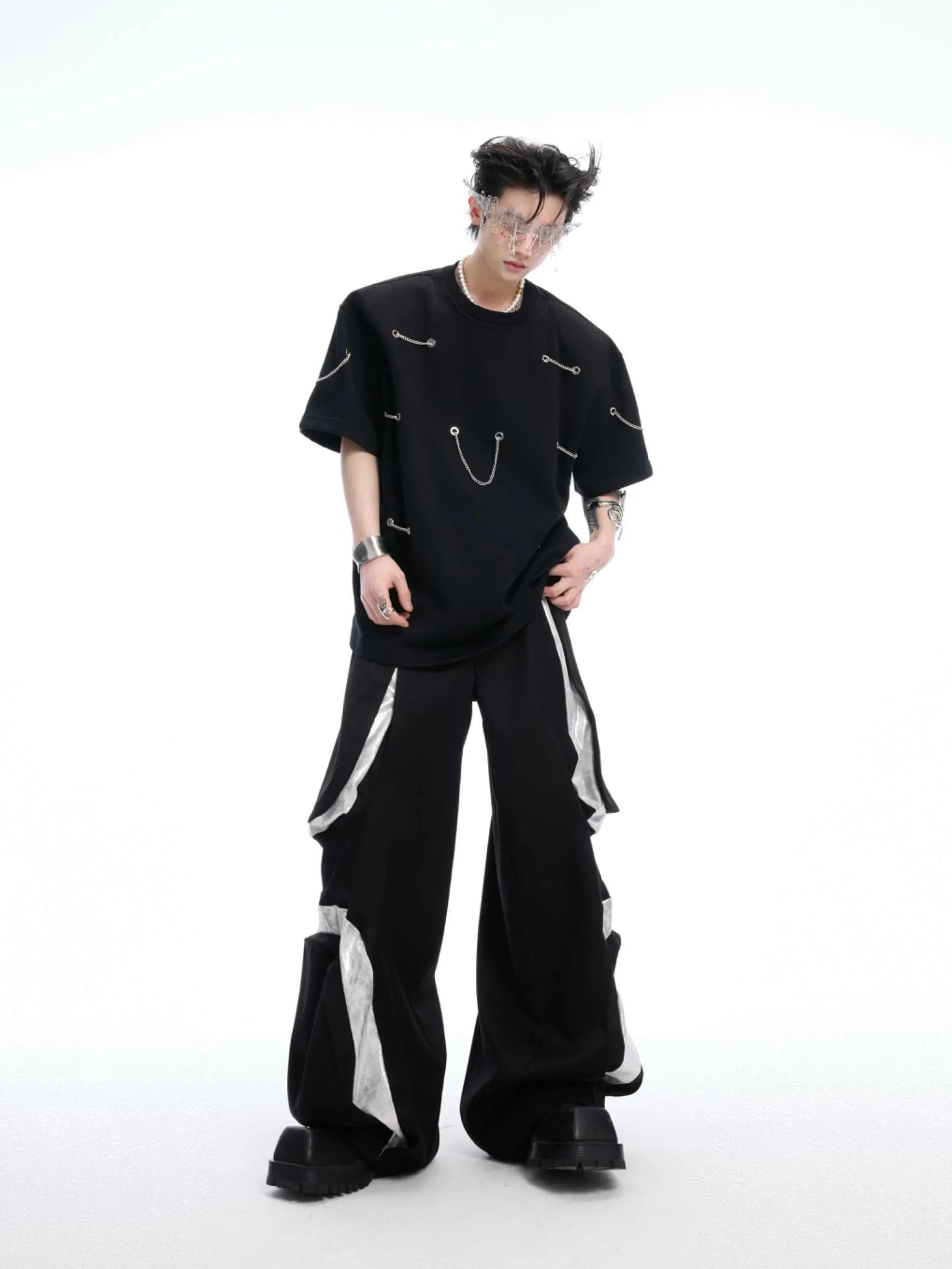 Black men's T-shirt with metal chain detail on padded shoulders, short sleeves, and round neck.