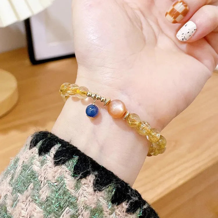 Women's gold rutilated quartz and sunstone crystal bracelet with round beads on elasticated band